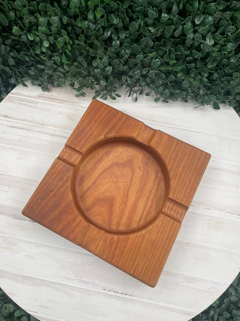 Cherry wood cigar ashtray, top-down view of the center bowl and cigar rests