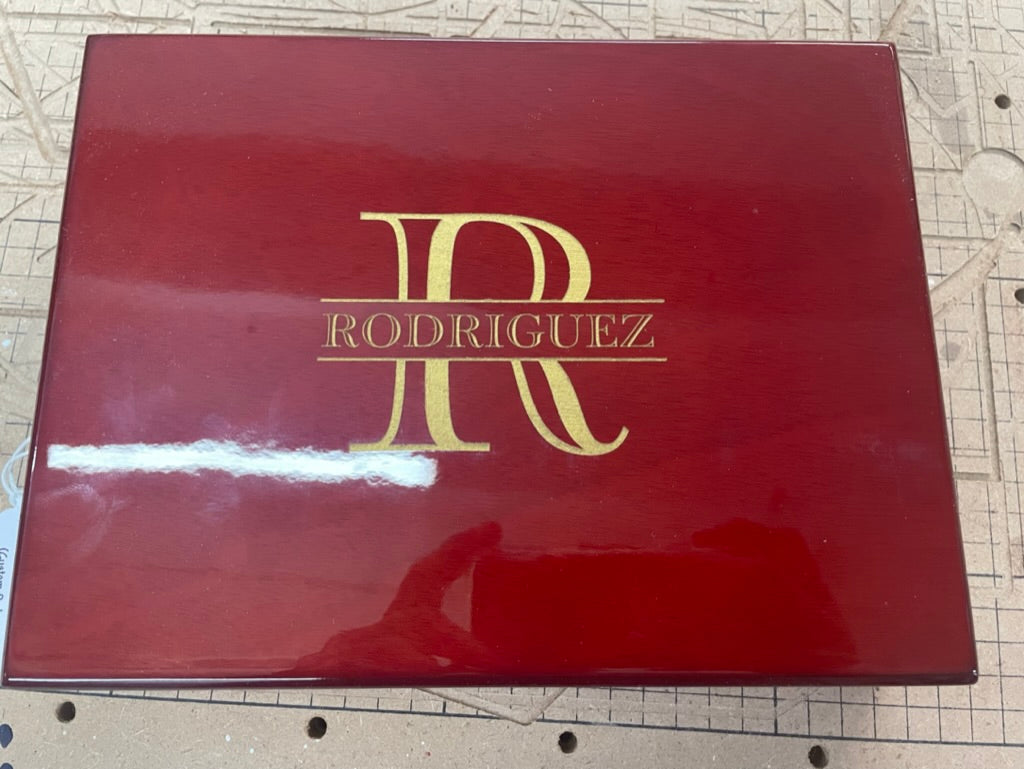 Rosewood cigar humidor lid engraved in gold with an R monogram and Rodriguez name