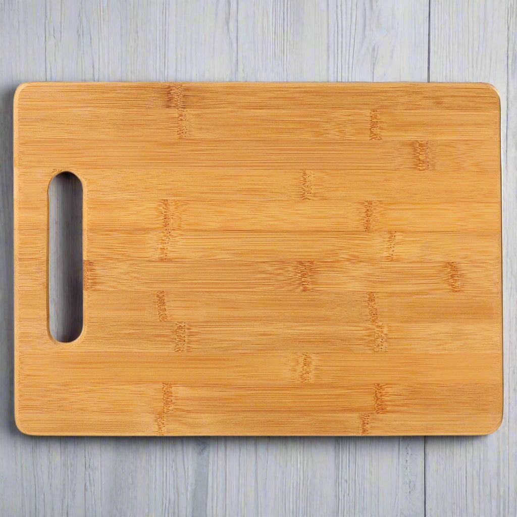 Bamboo rectangle cutting board with handle cutout, ready for custom engraving