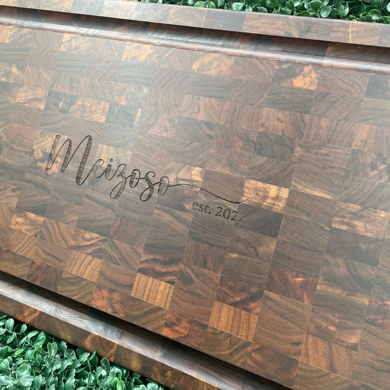 Engraved walnut butcher block cutting board cared for with food-safe oil