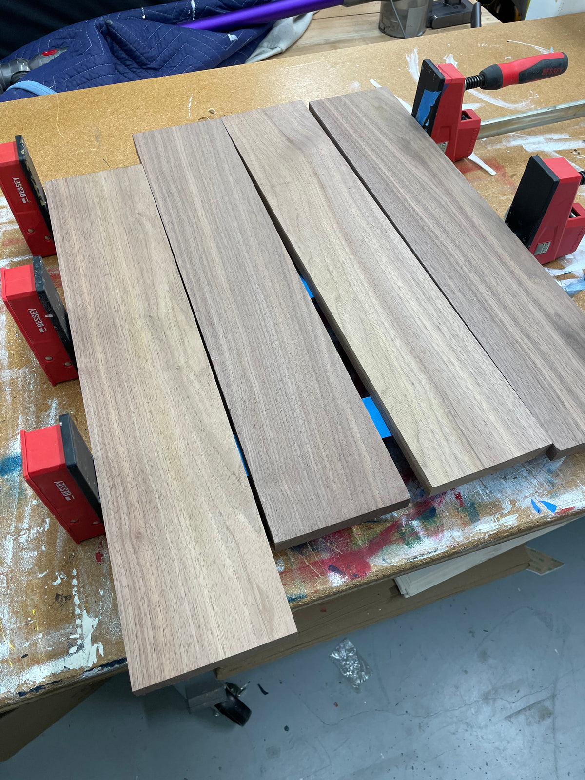 Planed black walnut boards prepared for a 20 inch round serving board