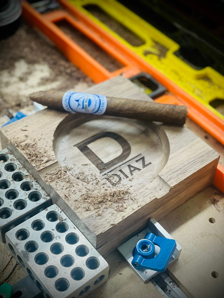 Black walnut ashtray engraved with the initial D and the Diaz family name