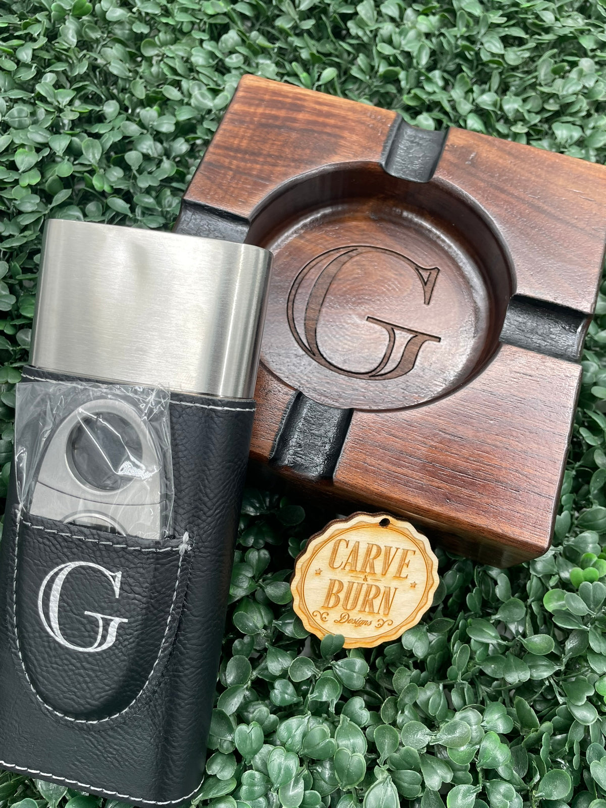 Black walnut ashtray with a G monogram cigar case and cutter set