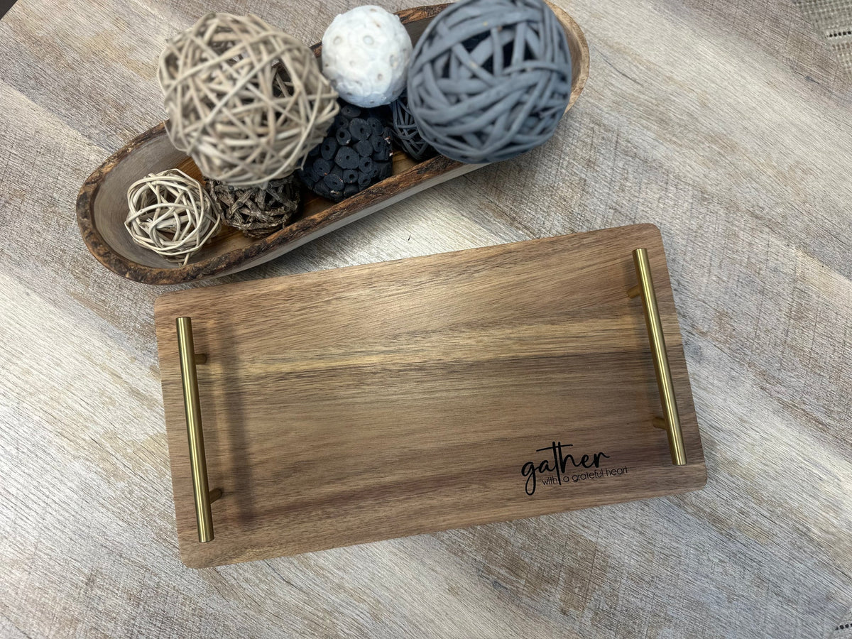 Personalized acacia serving tray with gold handles, engraved with a gather design