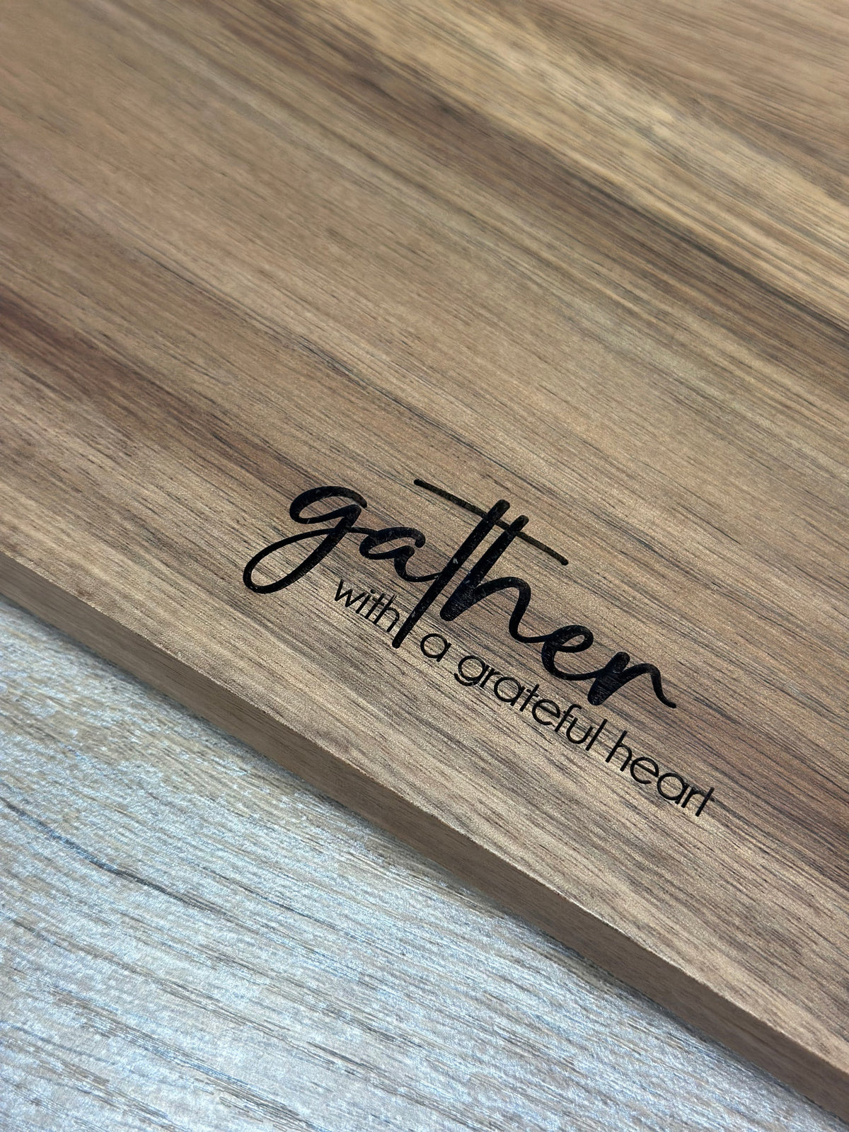 Close-up of laser engraving on acacia wood grain
