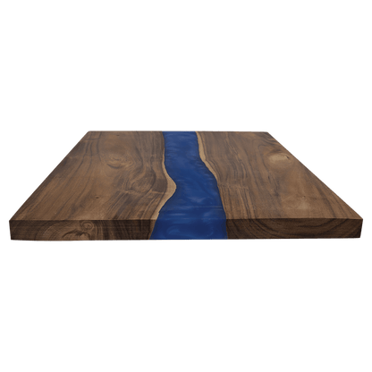Acacia charcuterie board with blue resin river inlay, angled view