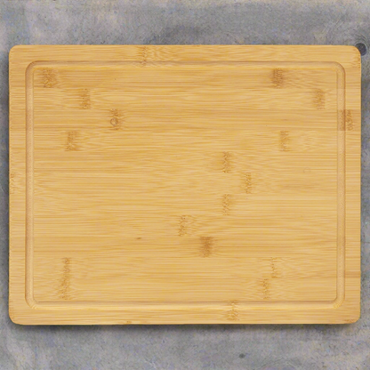 Bamboo cutting board with drip ring, 13.75 x 11 inch, top view on a gray counter
