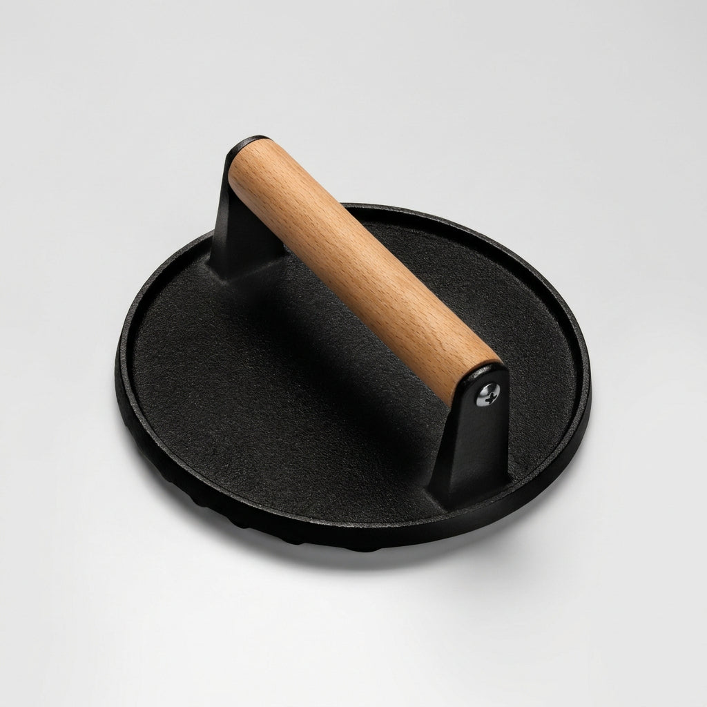 7 inch round cast iron burger press with wood handle, angled view