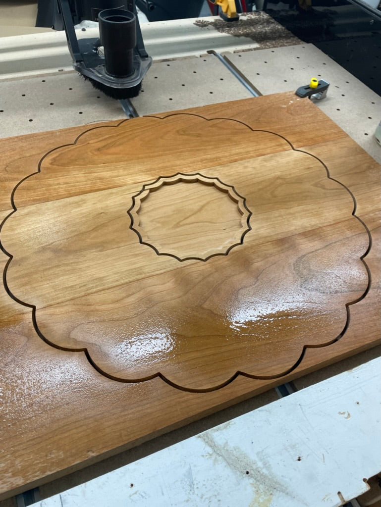 Cherry clamshell charcuterie board cut on the CNC machine with center dish recess