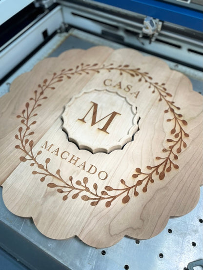 Cherry clamshell charcuterie board engraved Casa Machado on the laser engraver bed