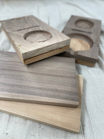 Cut wood blanks with cigar ashtray cutouts during production of the cigar gift set