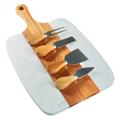 Marble and acacia serving board with four cheese knives, angled view
