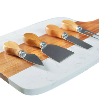 Marble and acacia serving board with cheese knives laid across it