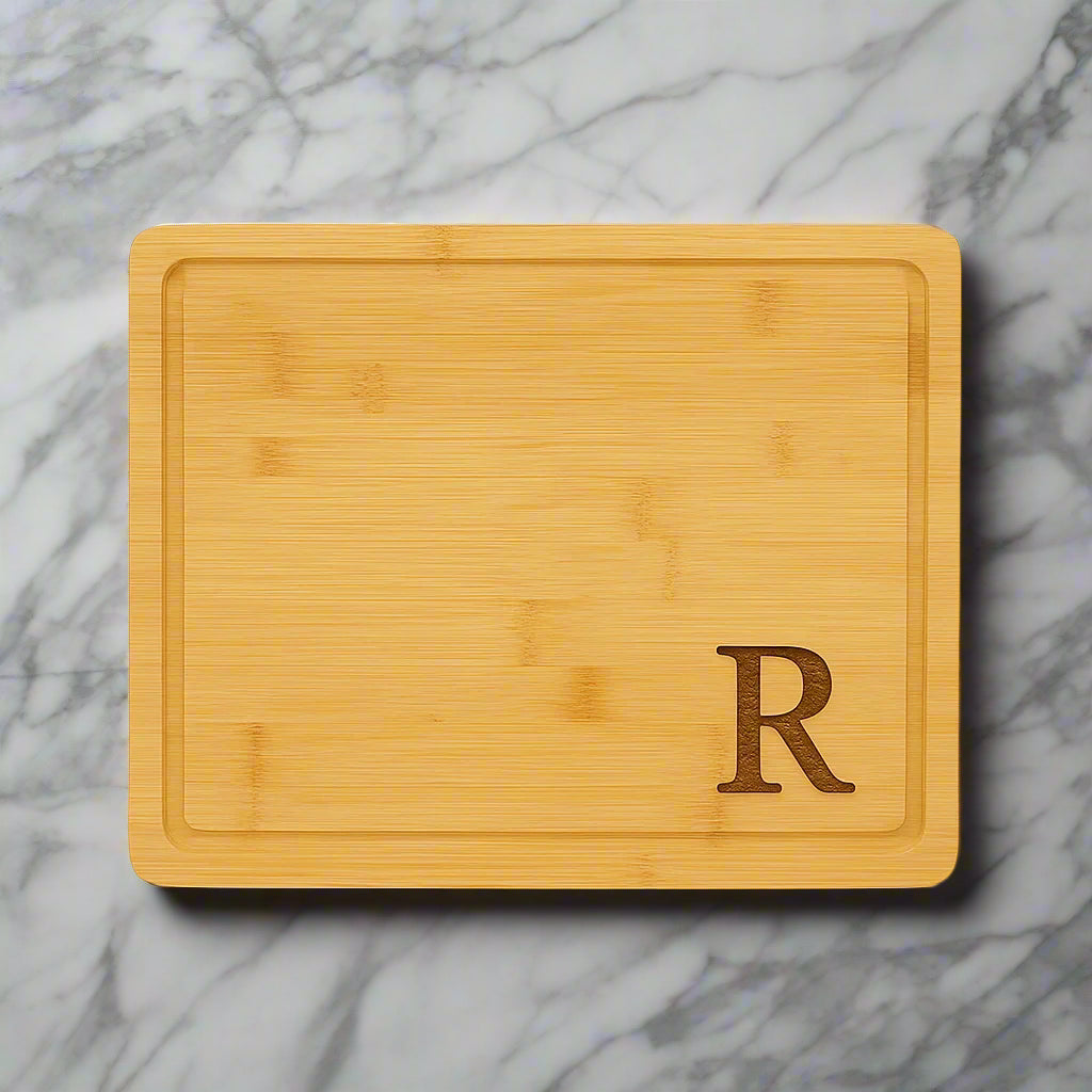 13 3/4 x 11 inch bamboo cutting board with drip ring, laser engraved with a monogram by Carve & Burn in Miami