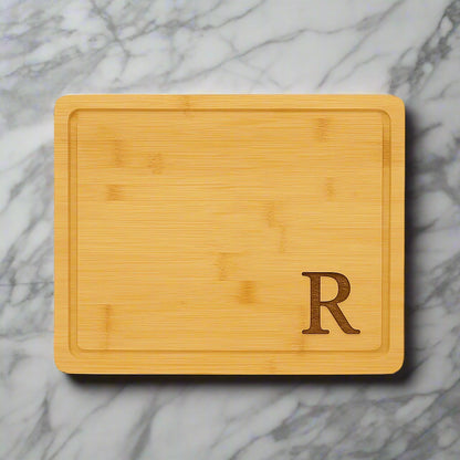 13 3/4 x 11 inch bamboo cutting board with drip ring, laser engraved with a monogram by Carve & Burn in Miami