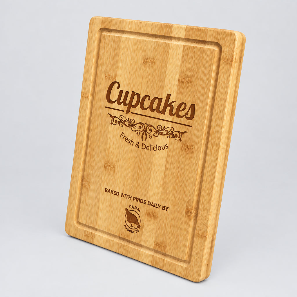 Bamboo cutting board with juice groove engraved with a Cupcakes bakery logo