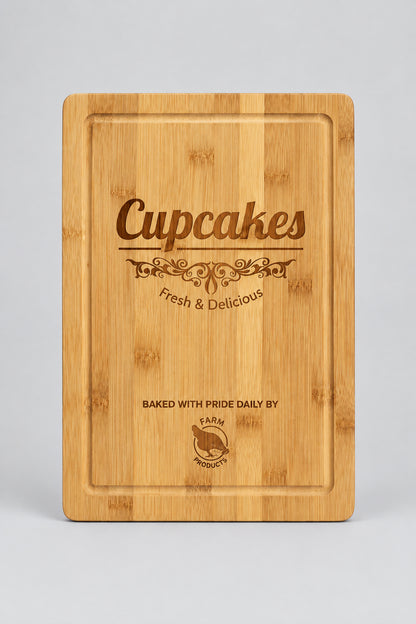 Bamboo cutting board with juice groove engraved with a Cupcakes bakery logo
