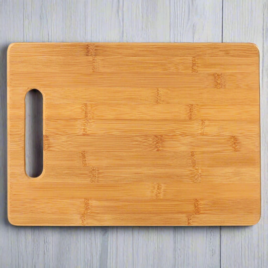Bamboo rectangle cutting board with handle cutout, ready for custom engraving