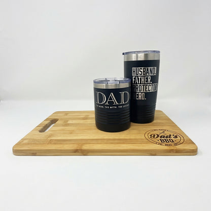 Dad's BBQ bamboo cutting board with matching engraved black Dad tumblers