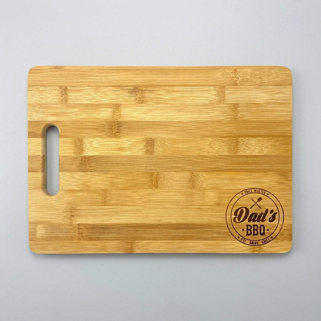 Small 9.75 x 13.75 inch bamboo cutting board engraved with a Dad's BBQ badge