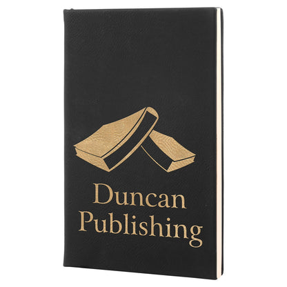 Black leatherette journal engraved in gold with a Duncan Publishing logo