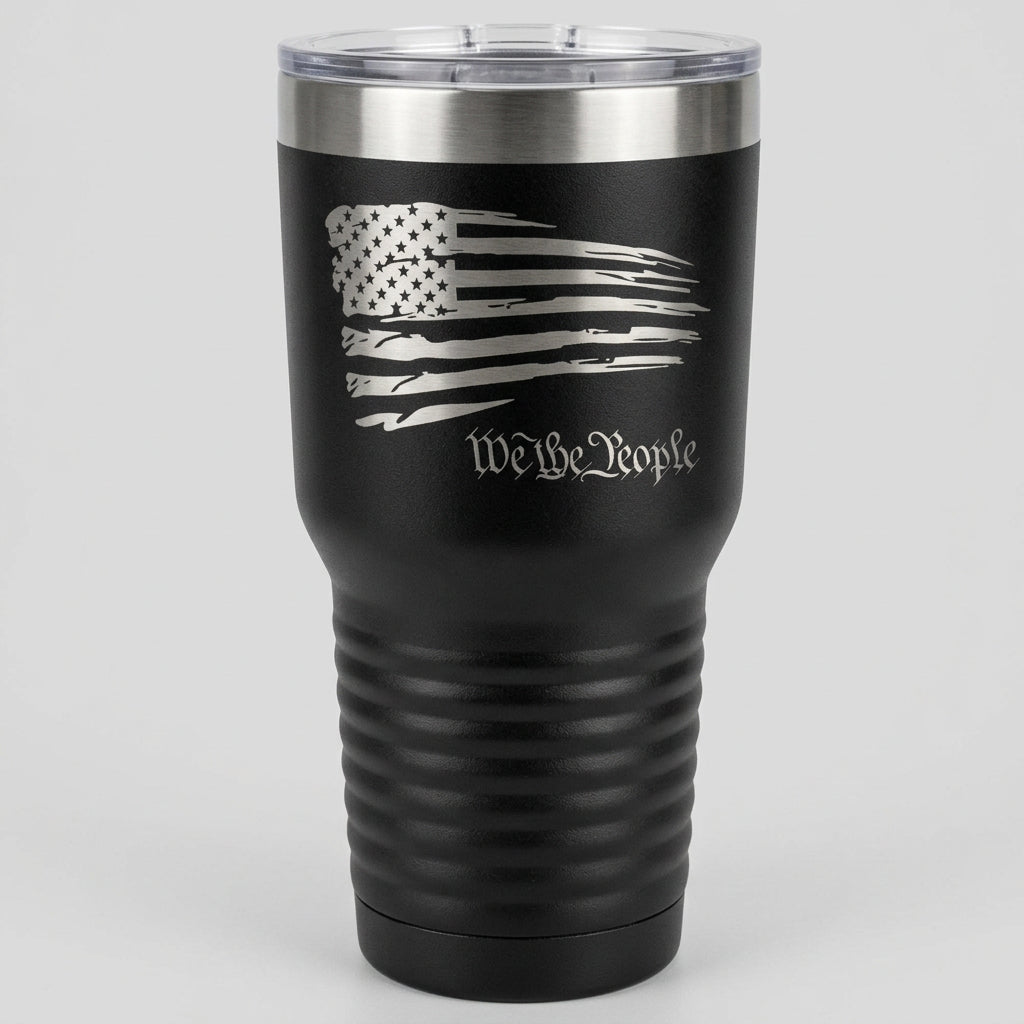 A 30 oz black tumbler with a design of the American flag and the text 'We the People' on it.