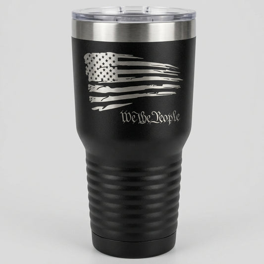A 30 oz black tumbler with a design of the American flag and the text 'We the People' on it.