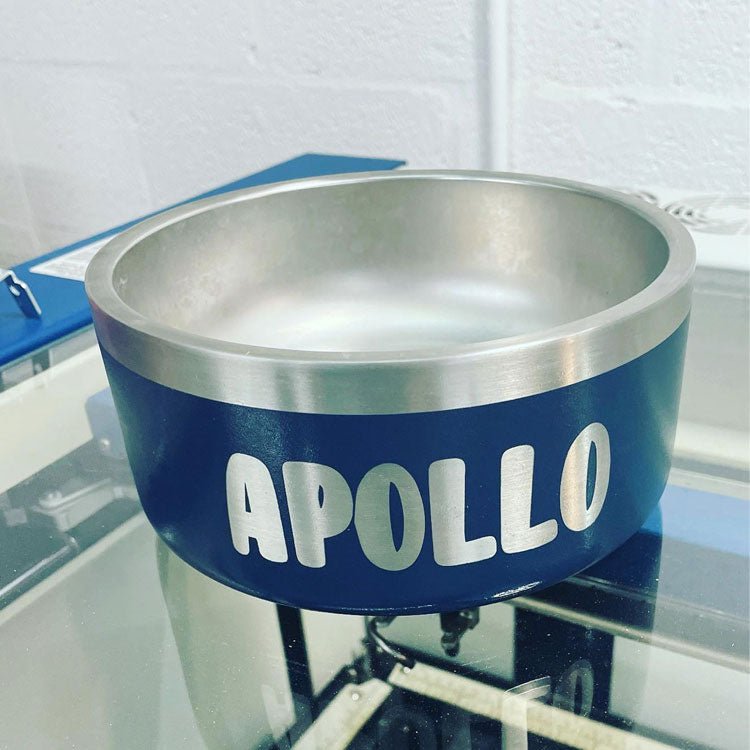 Navy stainless steel dog bowl laser engraved with the name Apollo in block letters